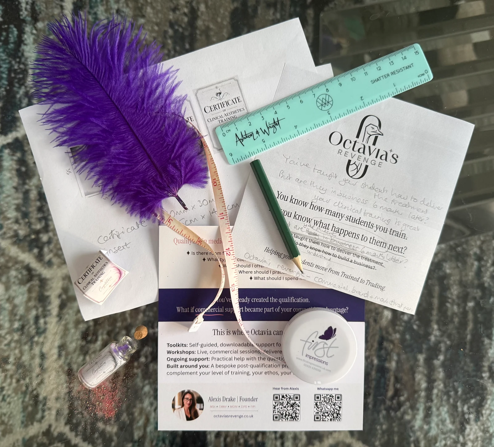 Octavia's Revenge direct-mail materials with a purple feather, miniature certificate, measuring tape, ruler and printed business support information.